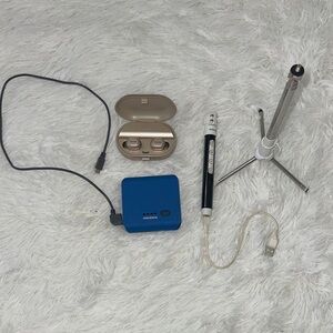 Anker Blue Power Bank, Beige Earbuds and Black Tripod/Selfie Stick